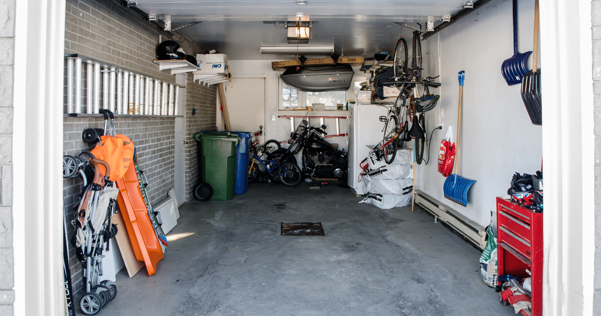 Garage converted into a storage space with bikes, tools, and household items, showing a simple house extension design idea.